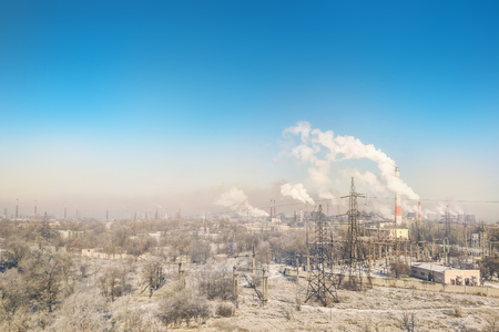 Panoramic view of city industrial area with many smoking stacks and pipes of plants and factories. Environmental pollution concept.の写真素材