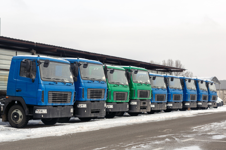 New middle size trucks at dealership parking outdoors at winter. Truck service and maintenance. Delivering and warehouse serviceの写真素材