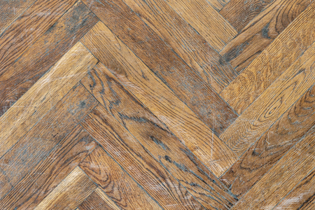 Old aged dirty herringbone parquet background. Natural weathered scratched oak hardwood textureの写真素材