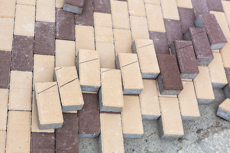 Row of stacks of gray pavement slab on wooden base . Concrete stone paving flag. Public pedestrian area renovation. Lamdcaping and renovation of Walkway zone in city parkの写真素材