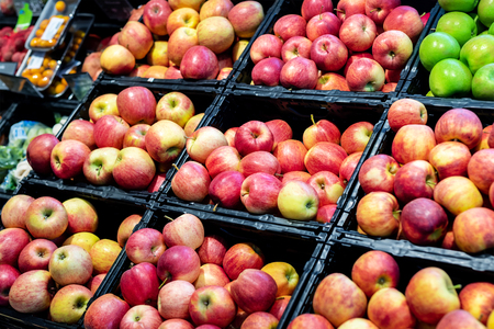Grocery supermarket store. Shelves with variety of different orgnaic fresh ripe apples. Vegetable and fruit marketの写真素材