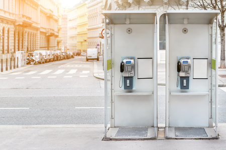 Pair of payphone booth in Vienna center street. Two modern public phones on european city street. copyspaceの写真素材