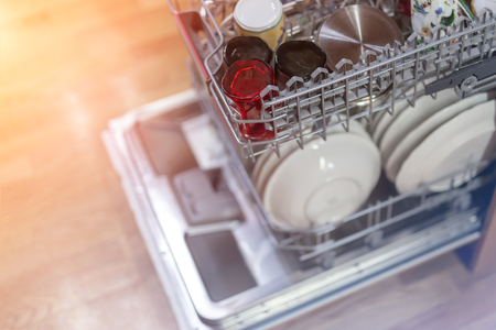 Open  dishwasher machine door after cleaning process finish in wooden house. Selective focus.の写真素材
