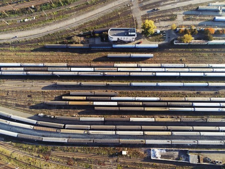 Aerial view of railroad yard with passenger and cargo trains on rail.の写真素材