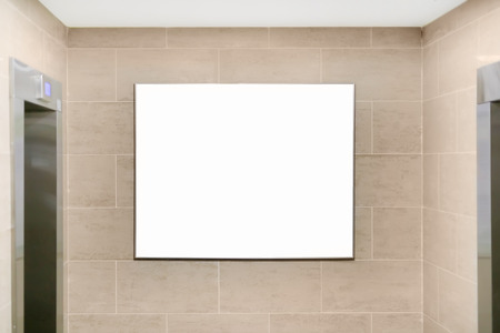 Interior of apartment or office building hall with elevators and  empty mockup signboard for advertisement, 	announcement or notice. White banner on wall near lifts.の写真素材