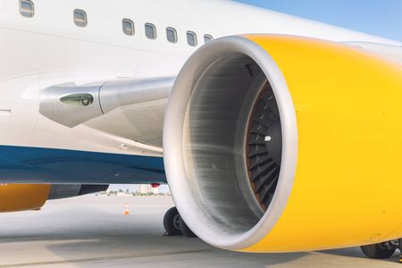 Close-up big commercial plane engine standing on airfiled after aircraft arrival on bright sunny day