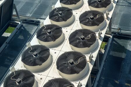 Heavy heating ventilation cooling and air conditioning set system on roof top of big industrial building.の写真素材