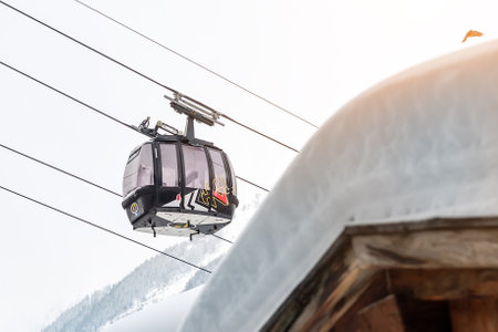 Ischgl, Austria- January 10th, 2018: Central square of austrian alpine winter resort Ischgl with hotels, tourists and Silvretta bahn ski-liftのeditorial素材