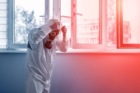 Man wearing protective biological suit and gas-mask due to mers coronavirus global pandemic warning...