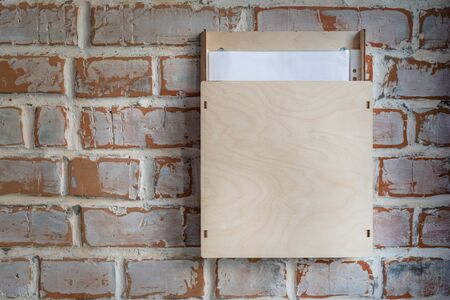 Old vintage brick wall with plywood box for anonymous paper notice, feedback, suggestion , opinions...
