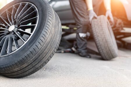 Car wheel repair shop outdoor ground . Seasonal winter tyre change at workshop. Vehicle tire repair, inspection and maintenance. Automotive garage for replace spare parts after failure breakdown.の写真素材