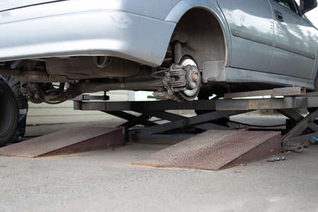 Car wheel repair shop outdoor ground . Seasonal winter tyre change at workshop. Vehicle tire repair, inspection and maintenance. Automotive garage with inflatable pneumatic air jacks. Copyspace textの写真素材