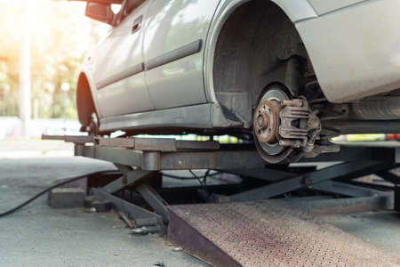 Car wheel repair shop outdoor ground . Seasonal winter tyre change at workshop. Vehicle tire repair, inspection and maintenance. Automotive garage with inflatable pneumatic air jacks. Copyspace textの写真素材