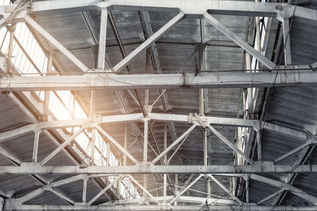 Old abandoned decay industry factory or plant roof ceiling interior with concrete and steel metal...