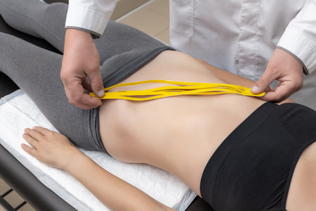 Suspended construction craddle near wall of hightower residentaial building with insulation and ventilated facade on construction site. Engineering urban backgroundの写真素材