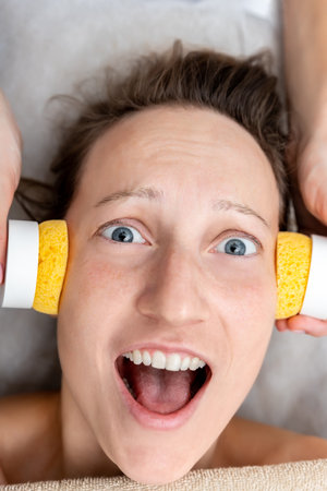 Fun portrait of young adult mid age caucasian woman afraid and screaming at beautician cosmetic...