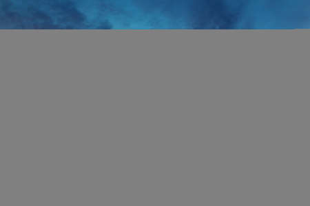 Dramatic colorful red orange to dark blue sunset or sunrise sky landscape clouds. Natural beautiful cloudscape dawn background wallpaper. Stormy windy nature twilight dusk scene panoramaの写真素材