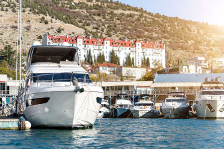 Scenic view of many luxury sailing fishing boat and charter rental speedboats moored at mountain...