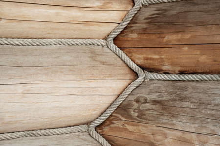 Close-up detail view of wooden log building corner joint decorated with jute rope isolation sealant....