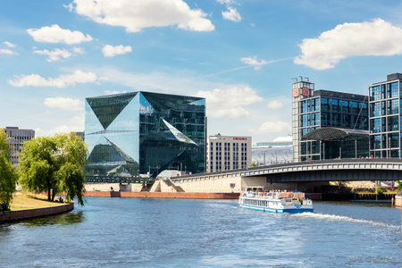 Scenic panoramic view of modern business center near Berlin DB railway central station from tourist ship sailing on river Spree on sunny day. Germany travel destiantaion.June 16th - Berlin, Germanyのeditorial素材