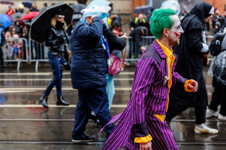 Erfurt, Germany - 11th February, 2024: Traditional german Carnival Fasching 2024 at Thuringia. People city street celebrate festival dancing having fun floating city center during heavy rain weatherのeditorial素材