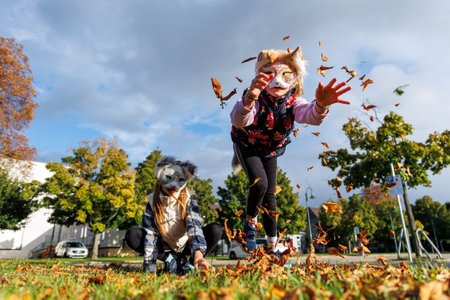 Cute young little kid girl wear cat furry mask enjoy have fun playing outdoors in forest street park. Children therian wild animal character trendy fan culture. Teenager social expression hobbyの写真素材