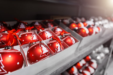 Many colorful bright festive Christmas handmade baubles toys decoration sale in boxes at factory manufacture store. Multicolored hand painted New year tree balls decor shopの写真素材