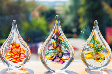 Colorful glass art sculptures displayed in sunlightの写真素材