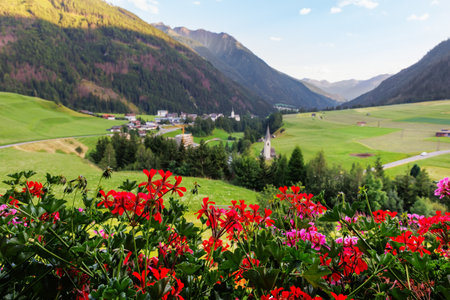 Scenic panorama alpine view flower decorated balcony austrian mountain village Kals am Grossglockner valley blue sky background. Austria Apls tirol National park nature. Summer autumn hiking tourismの写真素材