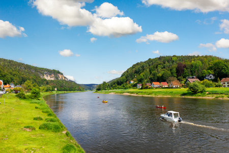 Panoramic scenic view rental boat cruising Elbe river curve Sachsische Schweiz National Park Germany Whelen Koenigstein mountain valley blue sky sunny day. Europe travel nature landscape destinationの写真素材