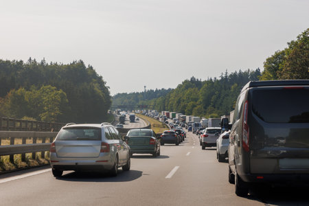 Back tail view of many cars stuck in row at highway road traffic jam cold overcast rainy winter day at Europe. Automobile accident vehicle rush hour collapse. Transportation vacation seasonal stuckの写真素材