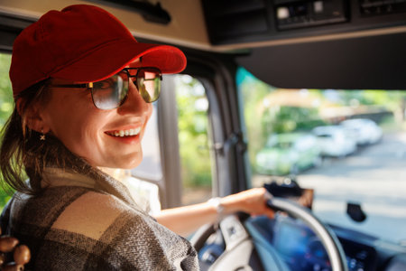 Portrait young adult happy smiling woman in cabin driving heavy truck driver modern cargo vehicle....