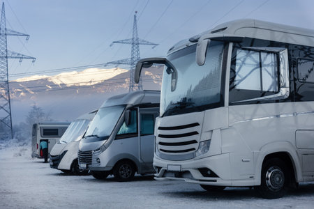 Scenic many different modern campervan motor home van parked camper park site lot Austria at sunrise sunset Kaprun mountain landscape. Motorhome campground station travel destination. RV lifestyleの写真素材