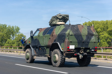 German military truck camouflage drives along autobahn green forest landscape during summer...