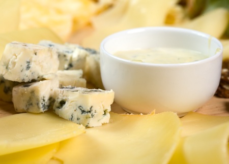 Various types of cheese on wooden platterの写真素材