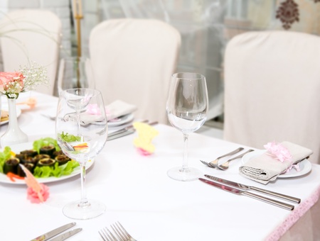 Modern tableware and glasses on a tableの写真素材