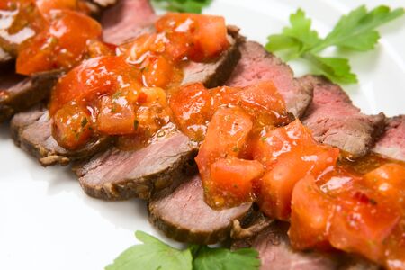 barbecue with sauce and vegetablesの写真素材