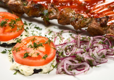 barbecue with sauce and vegetablesの写真素材