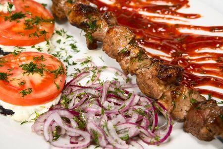 barbecue with sauce and vegetablesの写真素材