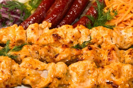 barbecue with sauce and vegetablesの写真素材