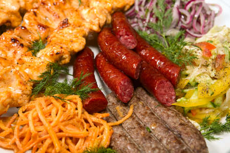 barbecue with sauce and vegetablesの写真素材