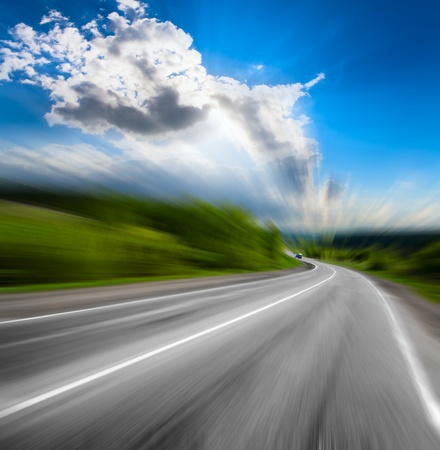 motion blurred road and cloudy blue skyの写真素材