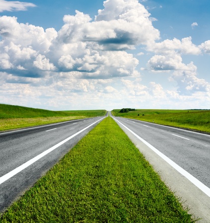 landscape with road and cloudy blue skyの写真素材