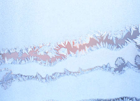 Frosty natural pattern on winter windowの写真素材