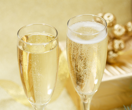 Two champagne glasses with gift boxesの写真素材