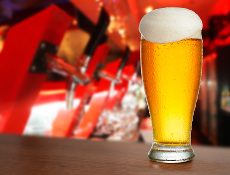 cold glass with beer on the background of bar.の写真素材