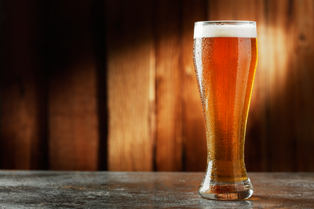 glass with beer on a wooden backgroundの写真素材