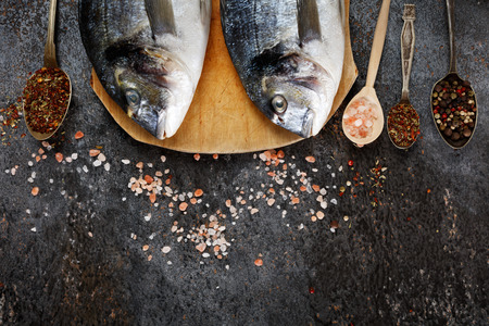 Top view of fresh fish dorado on grunge textured background. Copyspace.の写真素材