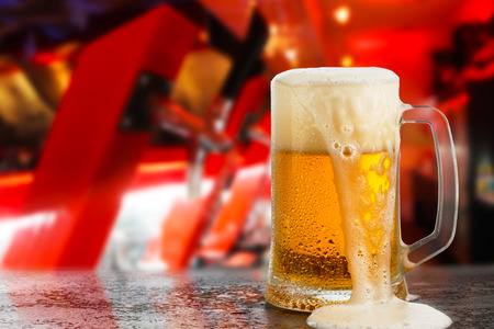 cold light beer glass mug in a pubの写真素材