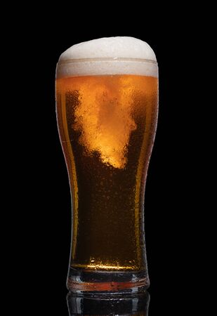Glass of beer isolated on black background.の写真素材